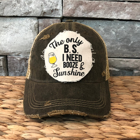 Vintage-style cap with a humorous quote on a woven surface and stone wall background