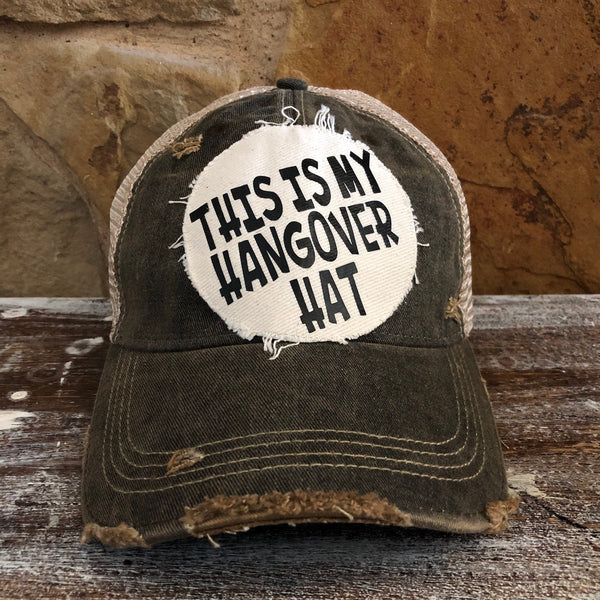 This Is My Hangover Hat by BohoGroove featuring a funny hand-applied patch on a Black vintage distressed snapback trucker hat.