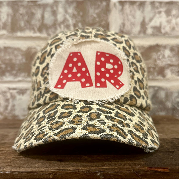 Arkansas Polka Dot hat by BohoGroove featuring a red polka dot AR design on a Leopard vintage distressed snapback trucker hat.