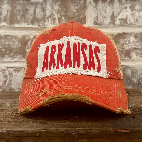 Arkansas hat by BohoGroove featuring a red ARKANSAS design on a Red vintage distressed snapback trucker hat.