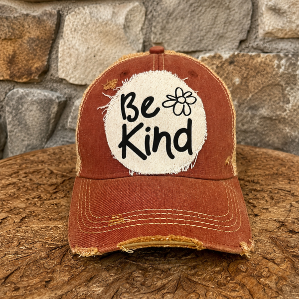 Be Kind hat by BohoGroove with black Be Kind lettering and flower graphic on distressed off-white patch on brick red vintage distressed snapback.