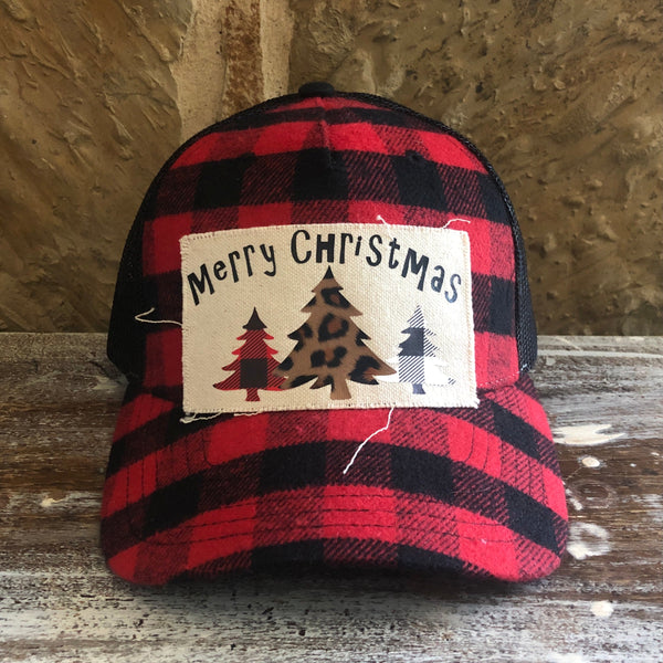 Buffalo Plaid Christmas Tree hat by BohoGroove with black Merry Christmas lettering and red, leopard print, and white Christmas tree graphics on a distressed off-white patch on a red and black buffalo plaid snapback trucker hat.