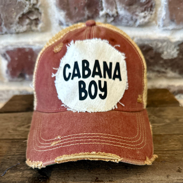 Cabana Boy hat by BohoGroove featuring black Cabana Boy lettering on a distressed off-white patch on a brick red vintage distressed snapback trucker hat.