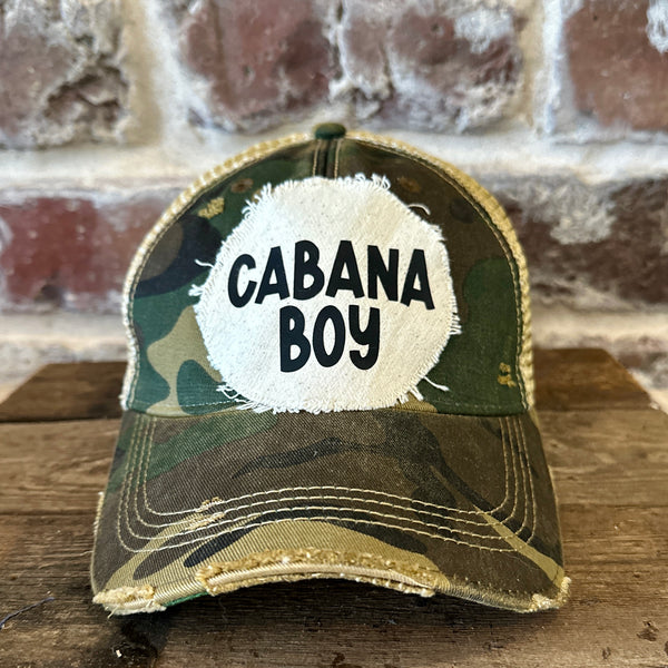 Cabana Boy hat by BohoGroove featuring black Cabana Boy lettering on a distressed off-white patch on a camo vintage distressed snapback trucker hat.
