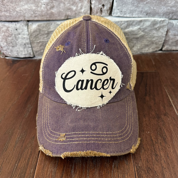 Cancer hat by BohoGroove with black Cancer lettering and constellation graphic on a distressed off-white custom patch on a purple vintage distressed snapback.