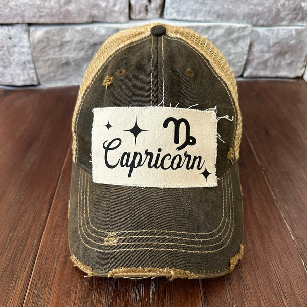 Capricorn hat by BohoGroove with black Capricorn lettering and constellation graphic on a distressed off-white custom patch on a black vintage distressed snapback.