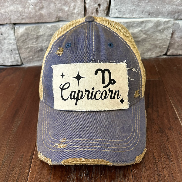 Capricorn hat by BohoGroove with black Capricorn lettering and constellation graphic on a distressed off-white custom patch on a royal blue vintage distressed snapback.