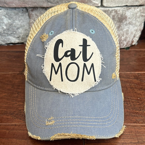 Cat Mom hat by BohoGroove with black Cat Mom lettering on a distressed off-white patch on a light blue vintage distressed snapback.