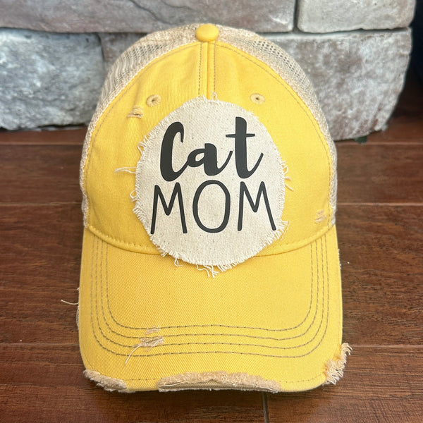 Cat Mom hat by BohoGroove with black Cat Mom lettering on a distressed off-white patch on a yellow vintage distressed snapback.