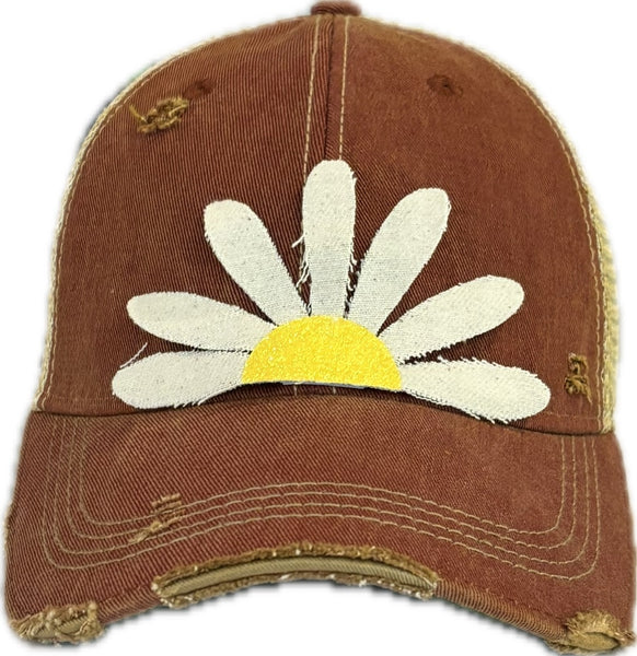 Daisy hat by BohoGroove featuring white daisy petals with a yellow glitter center on a brick red vintage distressed snapback trucker hat.