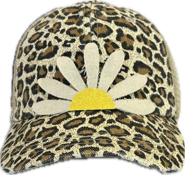 Daisy hat by BohoGroove featuring white daisy petals with a yellow glitter center on a leopard vintage distressed snapback trucker hat.