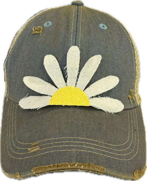 Daisy hat by BohoGroove featuring white daisy petals with a yellow glitter center on a light blue vintage distressed snapback trucker hat.