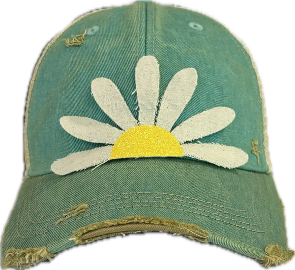 Daisy hat by BohoGroove featuring white daisy petals with a yellow glitter center on an ocean blue vintage distressed snapback trucker hat.
