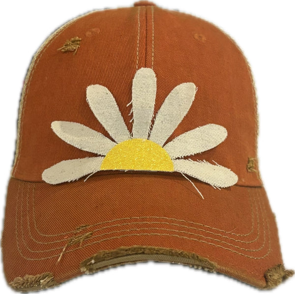 Daisy hat by BohoGroove featuring white daisy petals with a yellow glitter center on an orange vintage distressed snapback trucker hat.
