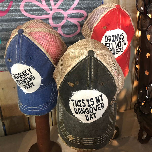Drinks Well With Others hat by BohoGroove displayed with funny vintage distressed drinking hats in multiple colors.