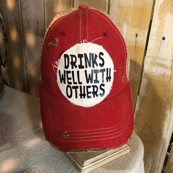 Drinks Well With Others hat by BohoGroove featuring a funny drinking patch on a red vintage distressed snapback trucker hat.
