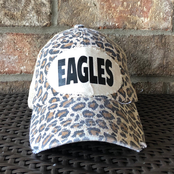Eagles hat by BohoGroove featuring a black EAGLES patch on a leopard vintage distressed snapback trucker hat.