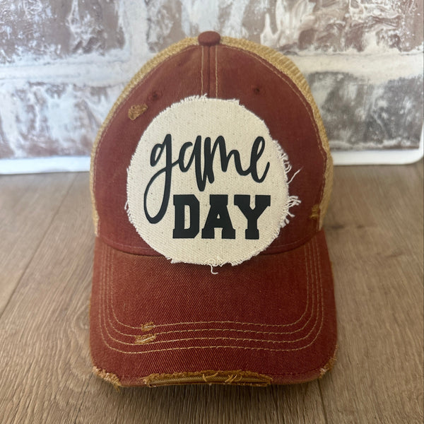 Game Day sports hat by BohoGroove with black Game Day lettering on distressed off-white patch on brick red vintage distressed snapback.