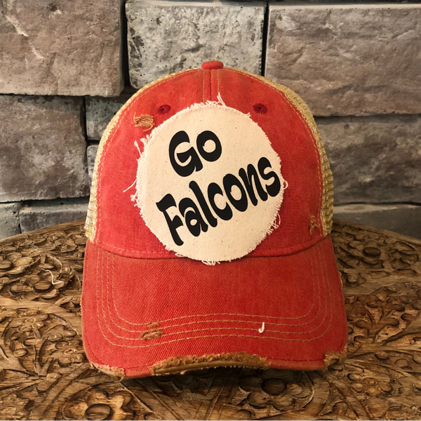 Go Falcons hat by BohoGroove featuring black Go Falcons lettering on a round cream frayed patch on a red vintage distressed snapback trucker hat.