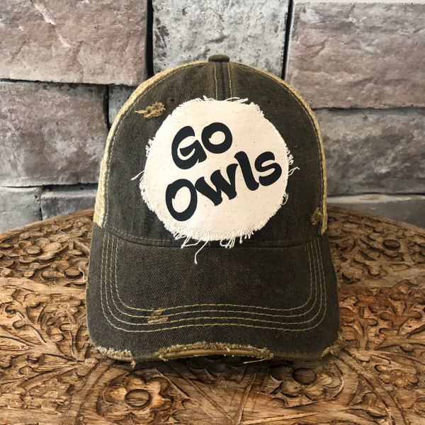Go Owls hat by BohoGroove featuring black Go Owls lettering on a round cream frayed patch on a black vintage distressed snapback trucker hat.