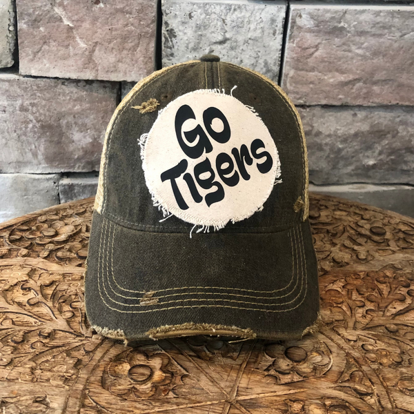 Go Tigers hat by BohoGroove featuring black Go Tigers  lettering on a round cream frayed patch on a black vintage distressed snapback trucker hat.