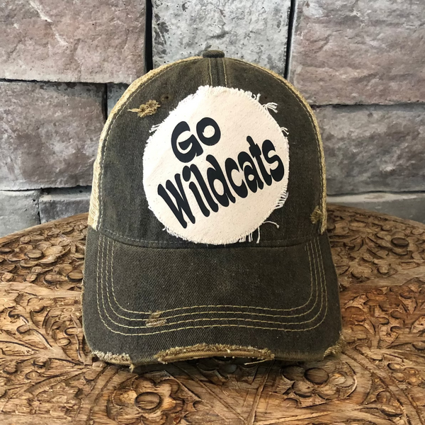 Go Wildcats hat by BohoGroove featuring black Go Wildcats lettering on a round cream frayed patch on a black vintage distressed snapback trucker hat.