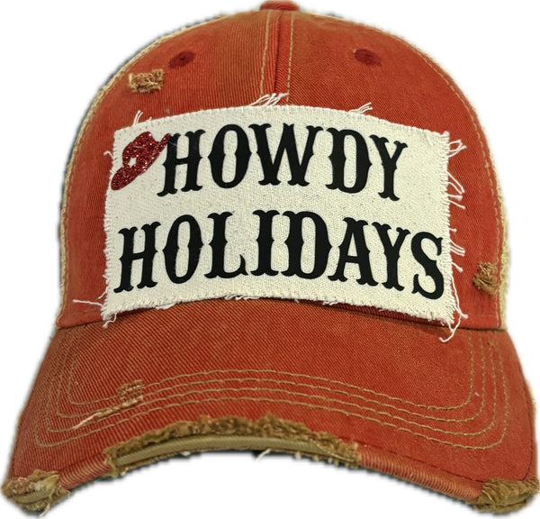 Red distressed cap with 'HOWDY HOLIDAYS' patch on a white background