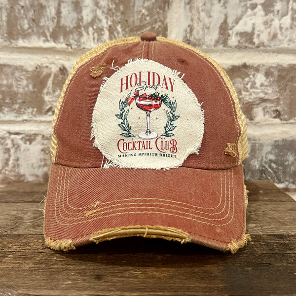 Holiday Cocktail Club hat by BohoGroove featuring a festive cocktail and Making Spirits Bright design on a Brick Red vintage distressed snapback trucker hat.