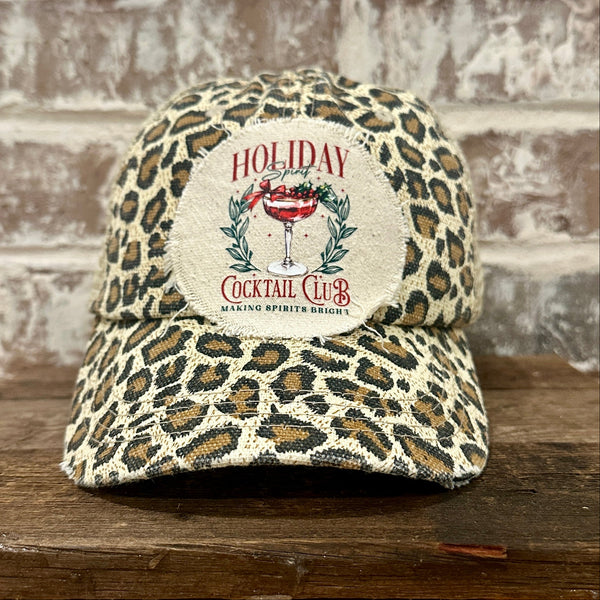 Holiday Cocktail Club hat by BohoGroove featuring a festive cocktail and Making Spirits Bright design on a Leopard vintage distressed snapback trucker hat.