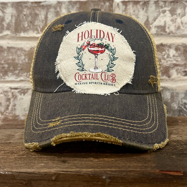Holiday Cocktail Club hat by BohoGroove featuring a festive cocktail and Making Spirits Bright design on a Navy vintage distressed snapback trucker hat.