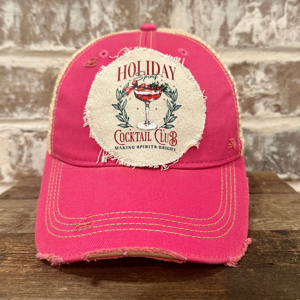 Holiday Cocktail Club hat by BohoGroove featuring a festive cocktail and Making Spirits Bright design on a Pink vintage distressed snapback trucker hat.