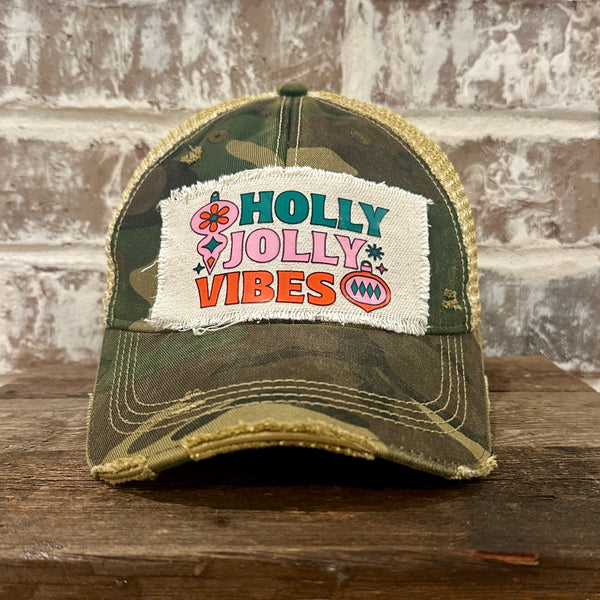 Holly Jolly Vibes hat by BohoGroove featuring a colorful retro Christmas design on a camo vintage distressed snapback trucker hat.
