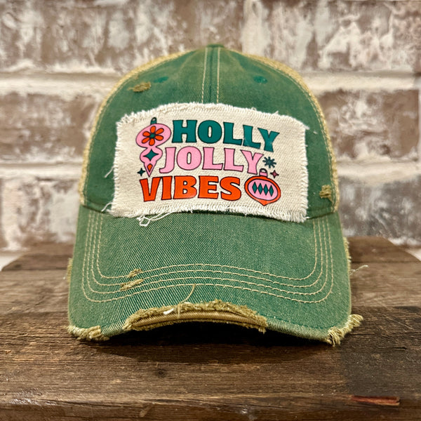 Holly Jolly Vibes hat by BohoGroove featuring a colorful retro Christmas design on a green vintage distressed snapback trucker hat.