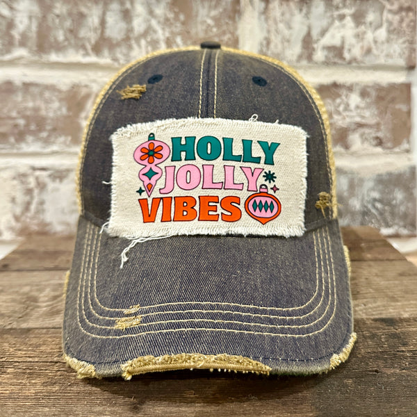 Holly Jolly Vibes hat by BohoGroove featuring a colorful retro Christmas design on a navy vintage distressed snapback trucker hat.