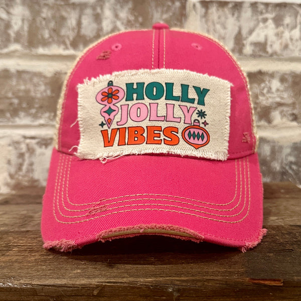 Holly Jolly Vibes hat by BohoGroove featuring a colorful retro Christmas design on a pink vintage distressed snapback trucker hat.