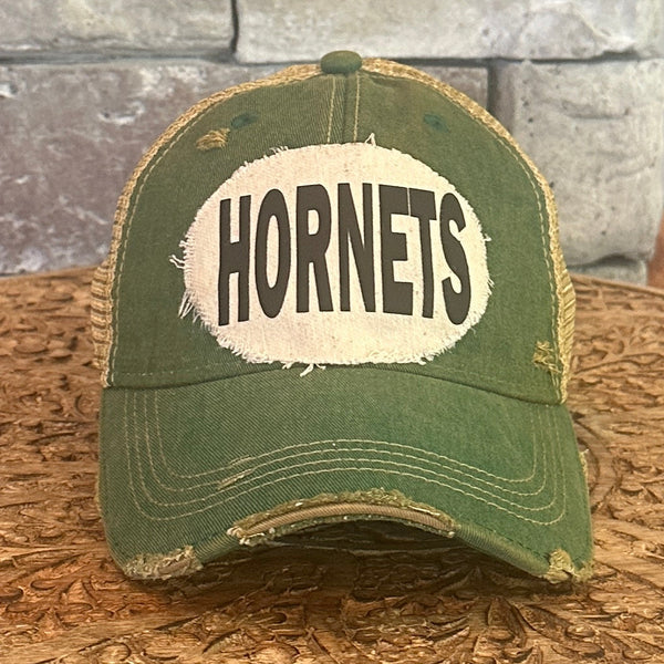 Hornets hat by BohoGroove featuring a cream Hornets patch with black writing on a green vintage distressed snapback trucker hat.