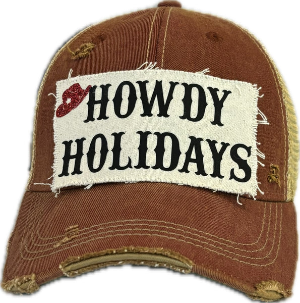 Howdy Holidays Cowboy Hat by BohoGroove with black Howdy Holidays lettering and a red glitter cowboy hat graphic on a distressed off-white custom patch on a brick red vintage distressed snapback.