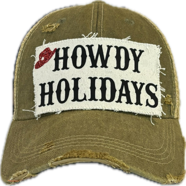 Howdy Holidays Cowboy Hat by BohoGroove with black Howdy Holidays lettering and a red glitter cowboy hat graphic on a distressed off-white custom patch on an olive vintage distressed snapback.