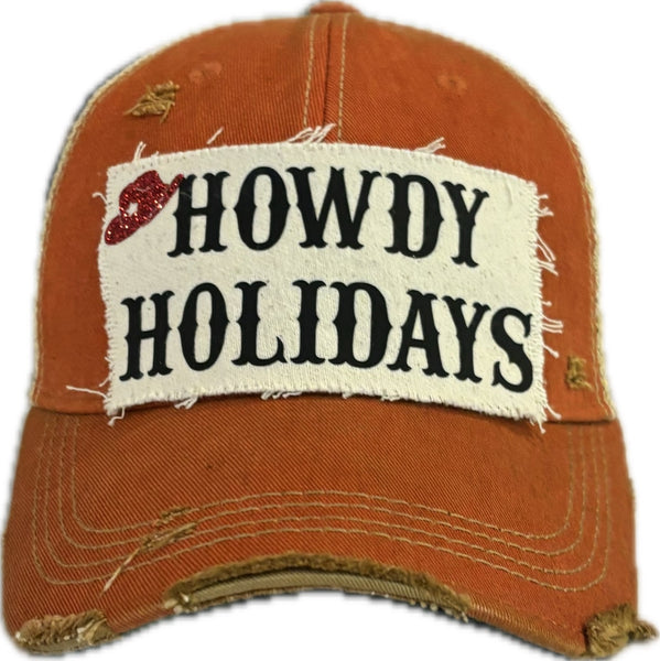 Howdy Holidays Cowboy Hat by BohoGroove with black Howdy Holidays lettering and a red glitter cowboy hat graphic on a distressed off-white custom patch on an orange vintage distressed snapback.