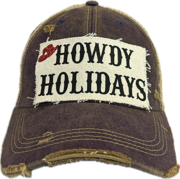 Howdy Holidays Cowboy Hat by BohoGroove with black Howdy Holidays lettering and a red glitter cowboy hat graphic on a distressed off-white custom patch on a purple vintage distressed snapback.
