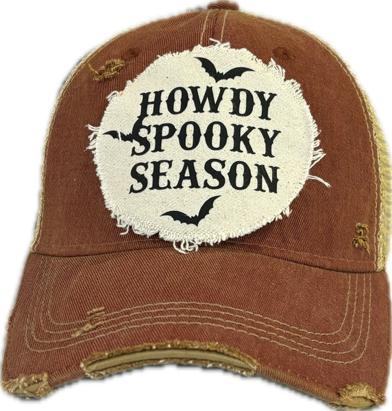 Howdy Spooky Season hat by BohoGroove with black wording and bat graphics on a distressed off-white patch on a brick red vintage distressed snapback trucker hat.