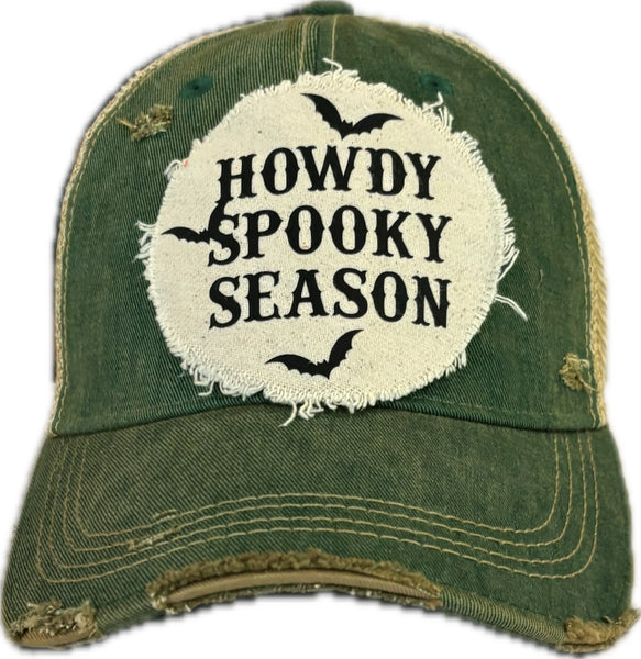 Howdy Spooky Season hat by BohoGroove with black wording and bat graphics on a distressed off-white patch on a green vintage distressed snapback trucker hat.