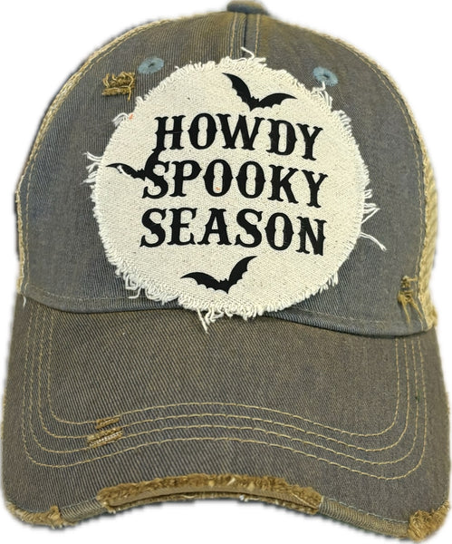 Howdy Spooky Season hat by BohoGroove with black wording and bat graphics on a distressed off-white patch on a light blue vintage distressed snapback trucker hat.