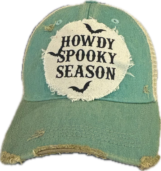 Howdy Spooky Season hat by BohoGroove with black wording and bat graphics on a distressed off-white patch on an ocean blue vintage distressed snapback trucker hat.