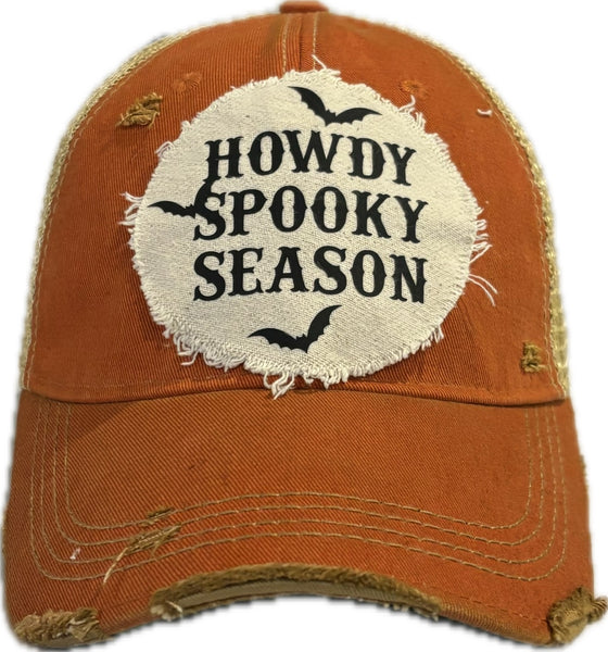 Howdy Spooky Season hat by BohoGroove with black wording and bat graphics on a distressed off-white patch on an orange vintage distressed snapback trucker hat.