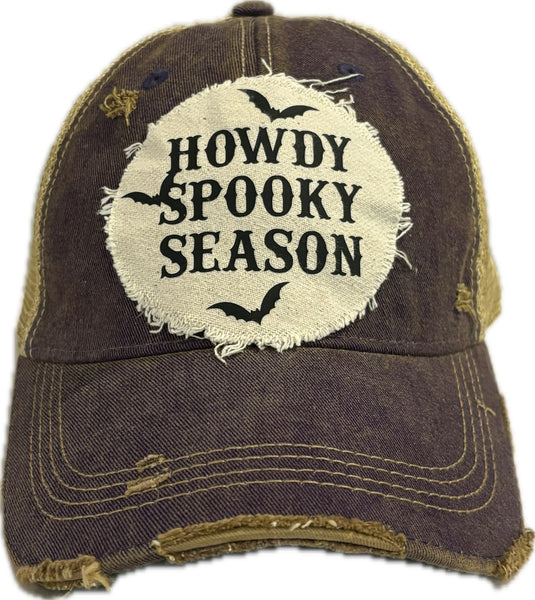 Howdy Spooky Season hat by BohoGroove with black wording and bat graphics on a distressed off-white patch on a purple vintage distressed snapback trucker hat.