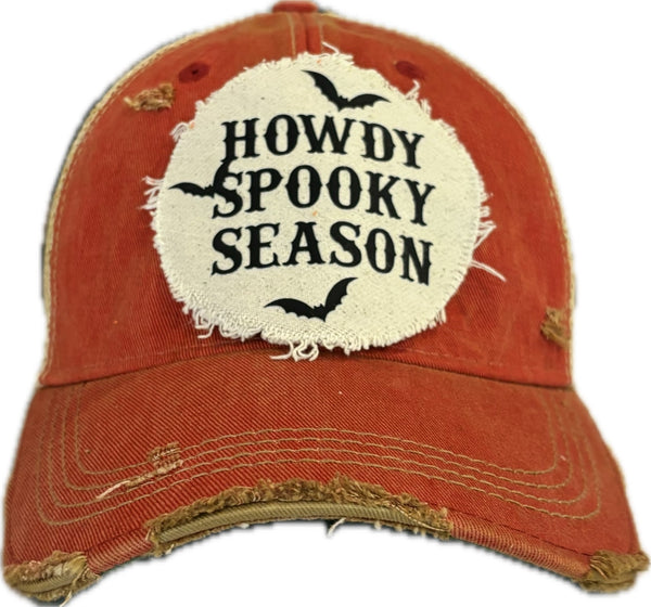 Howdy Spooky Season hat by BohoGroove with black wording and bat graphics on a distressed off-white patch on a red vintage distressed snapback trucker hat.