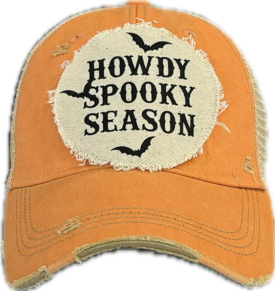 Howdy Spooky Season hat by BohoGroove with black wording and bat graphics on a distressed off-white patch on a sherbet vintage distressed snapback trucker hat.