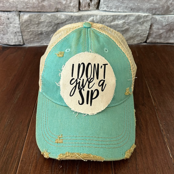 I Don't Give a Sip hat by BohoGroove featuring a funny drinking saying patch on an ocean blue vintage distressed snapback trucker hat.