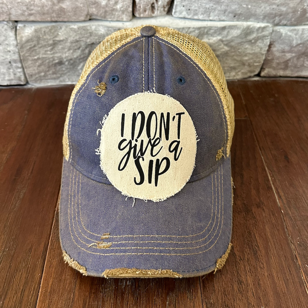 I Don't Give a Sip hat by BohoGroove featuring a funny drinking saying patch on a rpyal blue vintage distressed snapback trucker hat.
